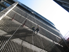 professional industrial abseilers installing scaffolding brackets for high-rise scaffolding