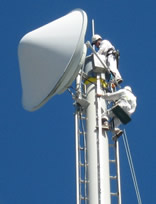 professional industrial abseilers putting up high rise advertising banner