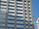 professional industrial abseilers putting up high rise advertising banner