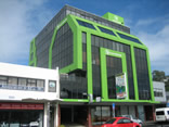 professional industrial abseilers putting up high rise advertising banner