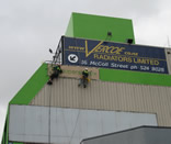 professional industrial abseilers sign writing on an Auckland high rise